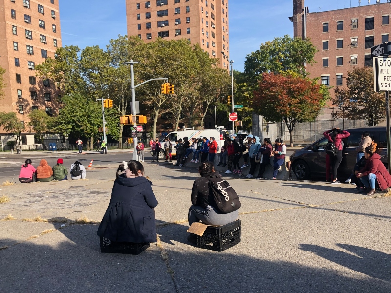 image of latina women waiting at the street   corner in Brooklyn